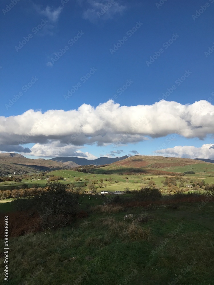 Mountain View with rugged countryside and  a dramatic blue sky background. Cumbria England. 