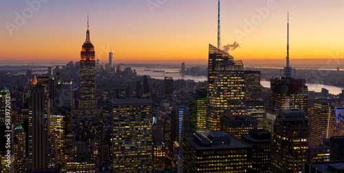 New York City aerial view of midtown Manhattan skyscrapers and Hudosn River at sunset