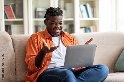 Chatty african american guy have video conference from home