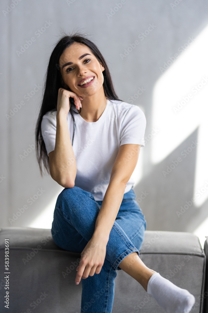 Beautiful young woman with laptop resting on couch at home Beautiful young woman with laptop resting on couch at home