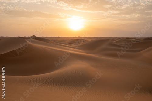 Sunset on the dunes in the empty quarter (desert), near Abu Dhabi in the United Arab Emirates.