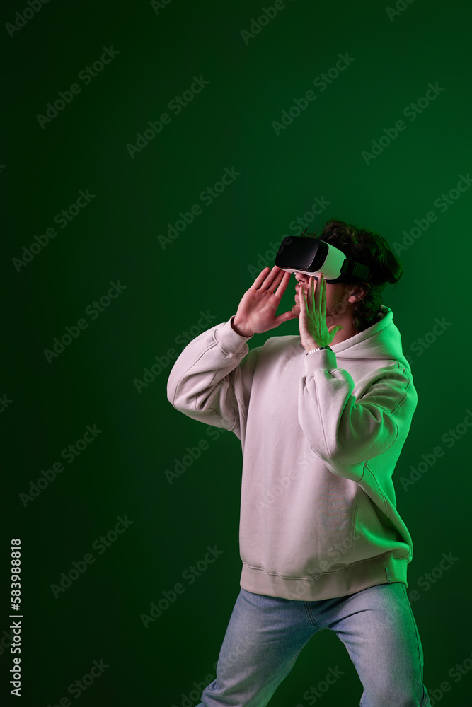 man in vr glasses and sweatshirt plays on blue background. man in vr glasses and sweatshirt plays on blue background.