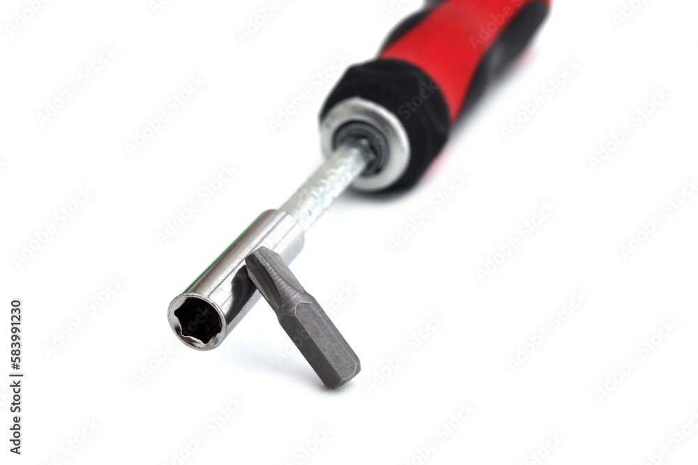A screwdriver with a removable tip lies on a white isolated background. A screwdriver with a removable tip lies on a white isolated background.