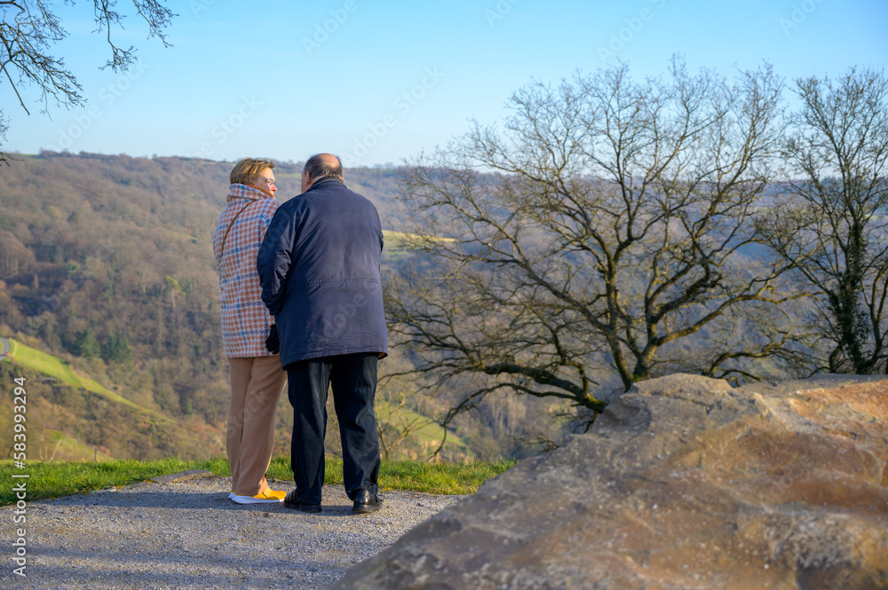 Senior couple looking at each other at a scenic overlook on a clear day