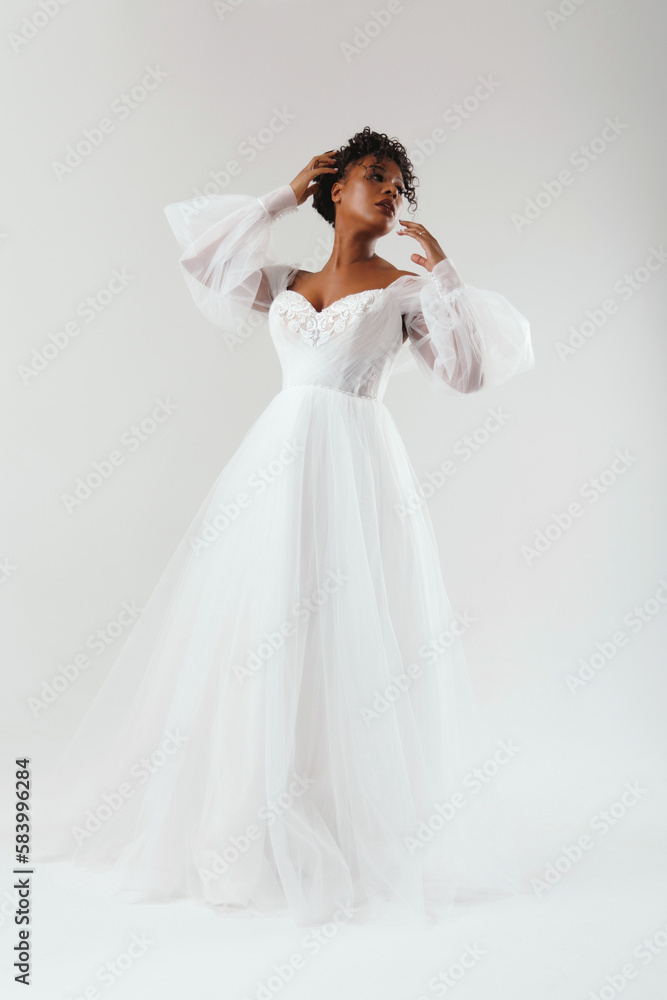 Happy african american woman in wedding dress. Fashion model in a white dress. Happy african american woman in wedding dress. Fashion model in a white dress.