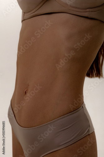 Young woman with naked belly. Close-up of a woman's belly.