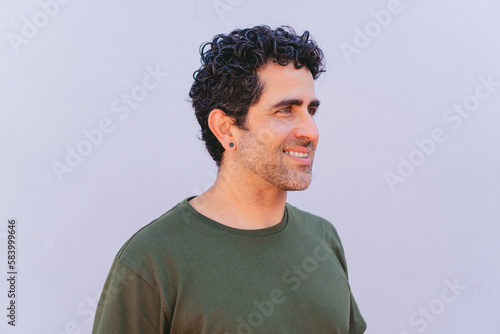 Wallpaper Mural Middle-aged latin model smiling in profile while posing on a white background. Torontodigital.ca