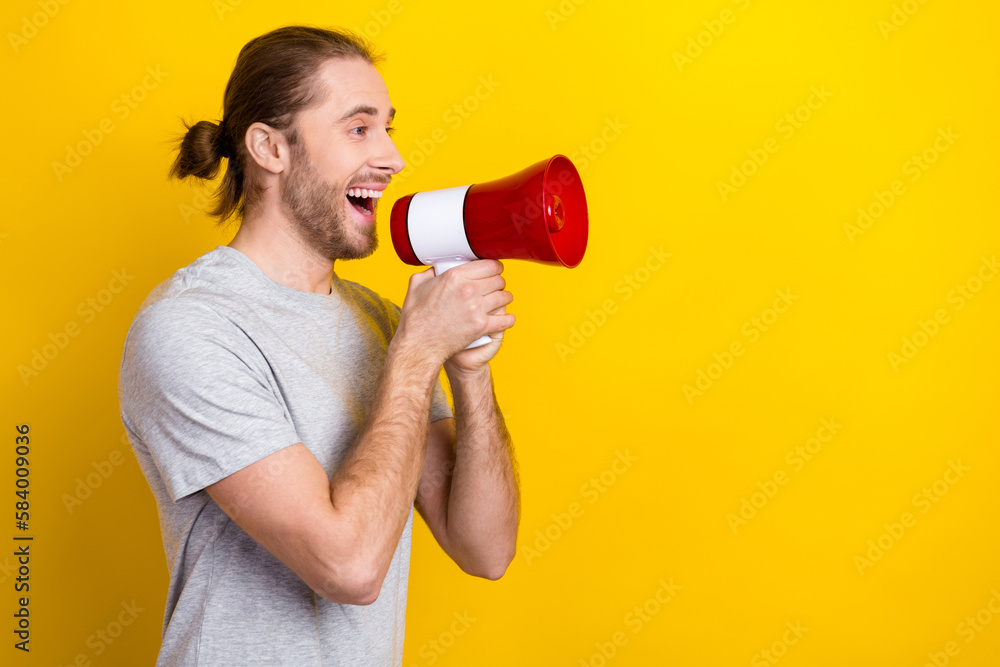 Profile side photo of positive cheerful man wear trendy clothes hold bullhorn share news low prices isolated on yellow color background