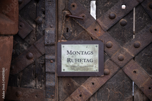 German Montags Ruhetag, Monday rest day sign at the metal wooden castle main door, Ronneburg Castle, Germany photo