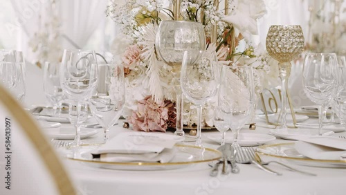 Restaurant served table with bouquet of flowers and dishware