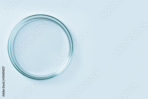 Empty petri dish made of blue glass. On a blue background.