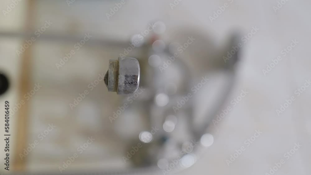 dripping faucet, close-up. water drops are falling. old plumbing. a dripping faucet covered with rust and limestone deposits. close the dripping water faucet in the bathroom. vertical video dripping faucet, close-up. water drops are falling. old plumbing. a dripping faucet covered with rust and limestone deposits. close the dripping water faucet in the bathroom. vertical video