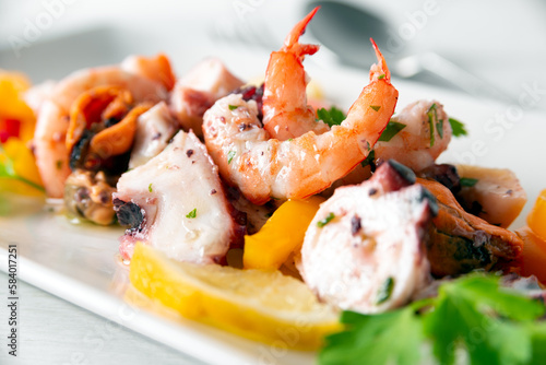 Deliziosa insalata di mare con gamberetti, polpo, calamari e cozze in salsa agrodolce, cibo italiano  photo