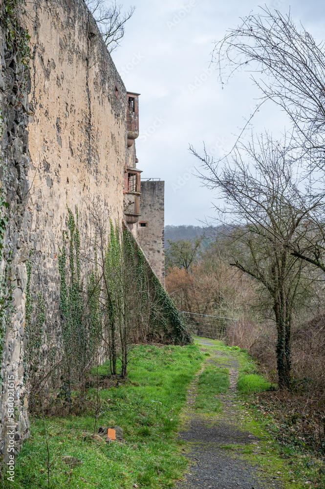 Ronneburg Castle walls with balcony and road next to the castle during cloudy day, Germany, vertical shot