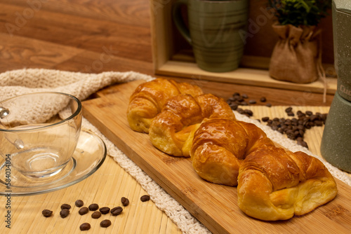 Argentinian breakfast. Croissants with coffee pot, cup and coffee beans in still life