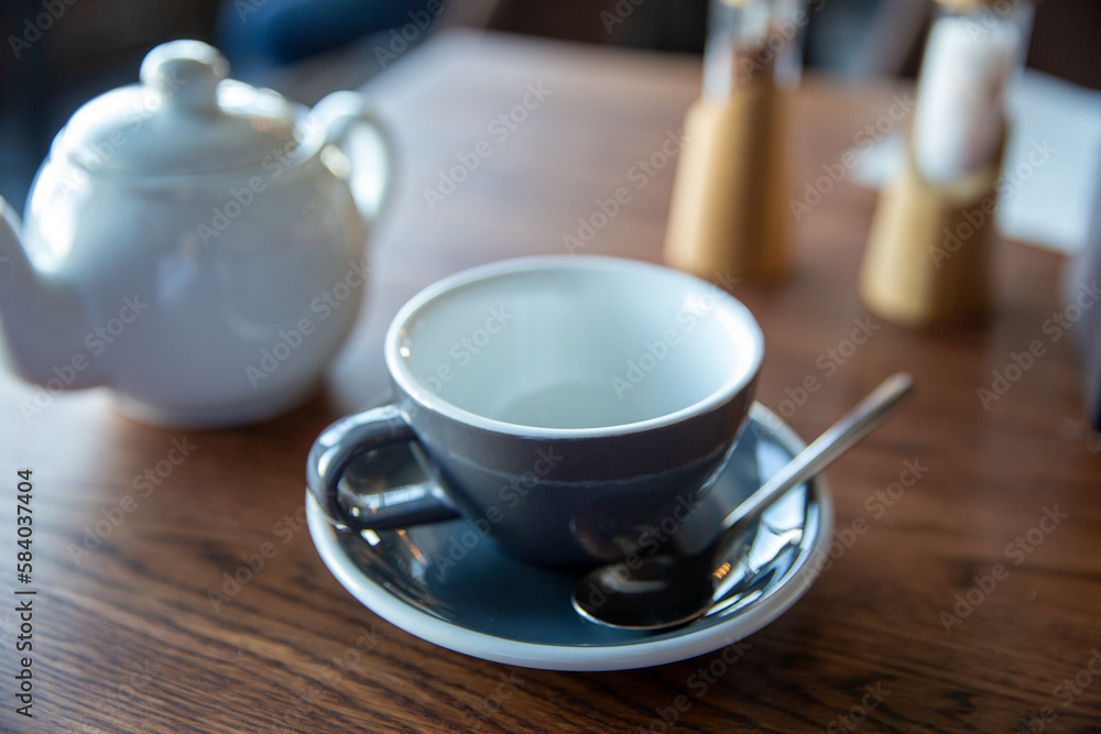 Teapot and cup and saucer on the table in restaurant Teapot and cup and saucer on the table in restaurant