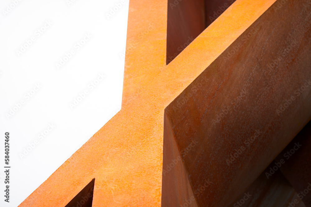 Iron letter X. Architectural forms with the letter X made of rusty metal closeup