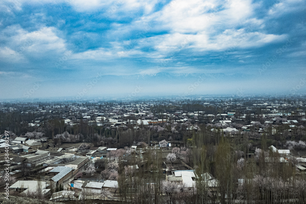 Breathtaking view from the top of the mountain showing houses below and clouds above. Tranquility and beauty in one frame