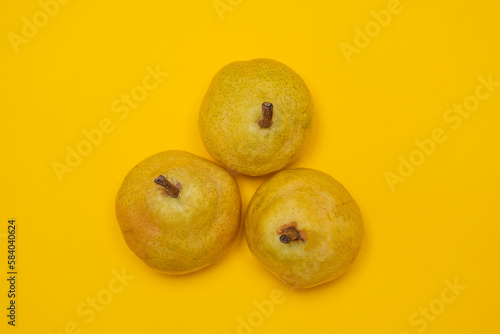 Organic Pear on a yellow. Juicy fruit, cool minimal flat lay, copy space.