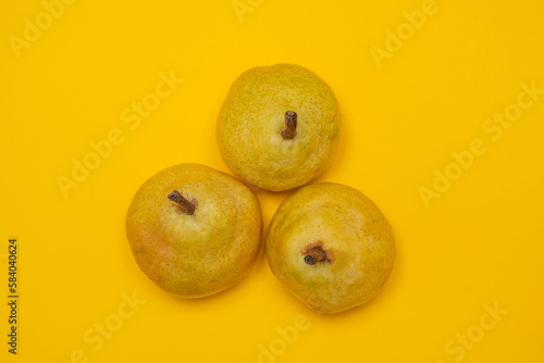 Organic Pear on a yellow. Juicy fruit, cool minimal flat lay, copy space. (ID: 584040624)