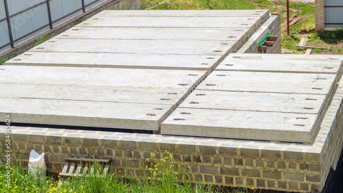 Installed reinforced concrete hollow core floor slabs. House construction at a construction site.