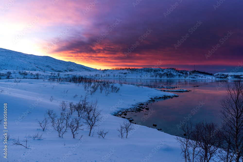 beautiful sunset in snowy nature and sea in tromso