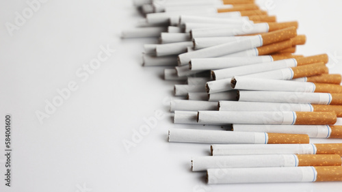 Many cigarettes on a white background. A strong passion for smoking. Harmful to health. Smoking can be harmful to your health. It s a pity for the environment. Health problem  causes cancer. Cigarette