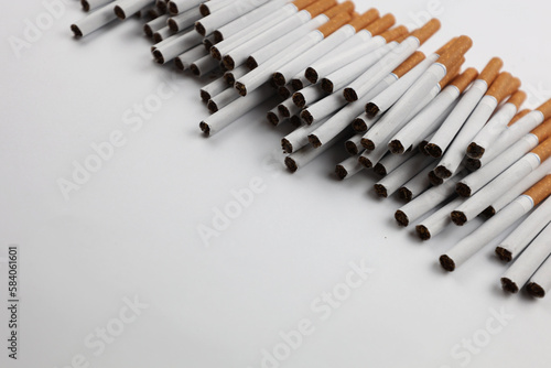 Many cigarettes on a white background. A strong passion for smoking. Harmful to health. Smoking can be harmful to your health. It s a pity for the environment. Health problem  causes cancer. Cigarette