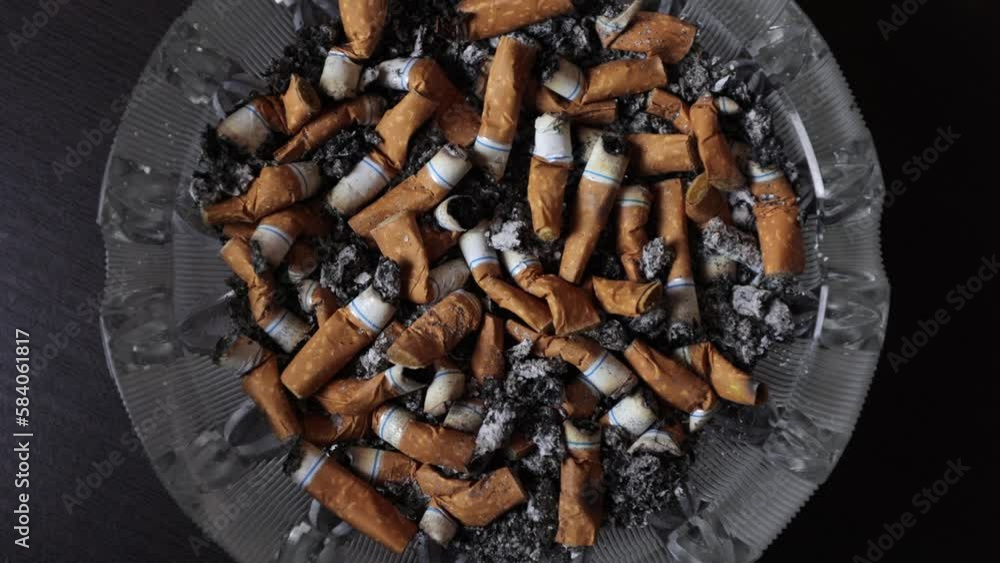 Cigarettes in an ashtray, ashes, many smoked cigarettes. A strong passion for smoking. Harmful to health. Smoking can be harmful to your health. It's a pity for the environment. Health problems.