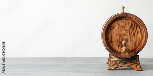 Wooden barrel on light background with space for text
