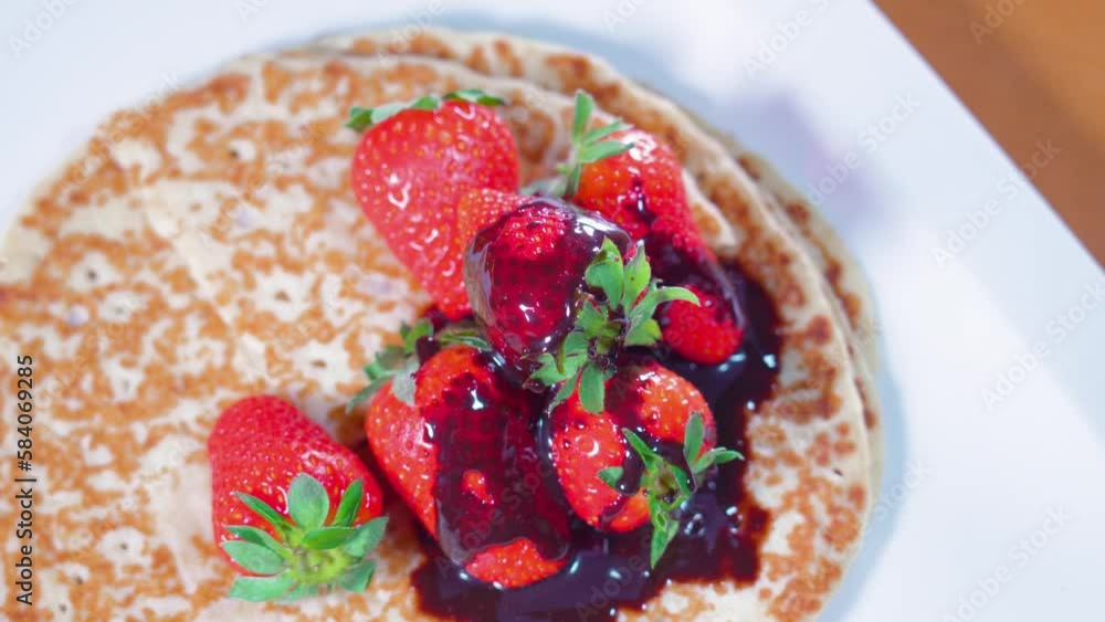 Strawberries with syrup on top on pancakes Strawberries with syrup on top on pancakes
