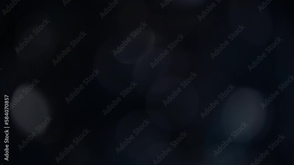 Pop-up and fading white blue bokeh on a black background. Abstract glowing moving background of defocused circles. Movement of blue and white bokeh light circles. Can be used as overlay or transition. Pop-up and fading white blue bokeh on a black background. Abstract glowing moving background of defocused circles. Movement of blue and white bokeh light circles. Can be used as overlay or transition.