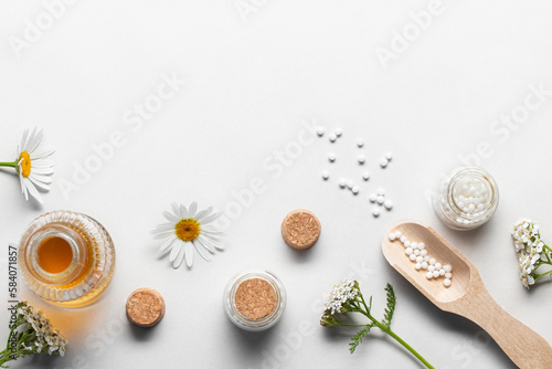 Homeopathic medicines and medicinal plants on a light background, copy space