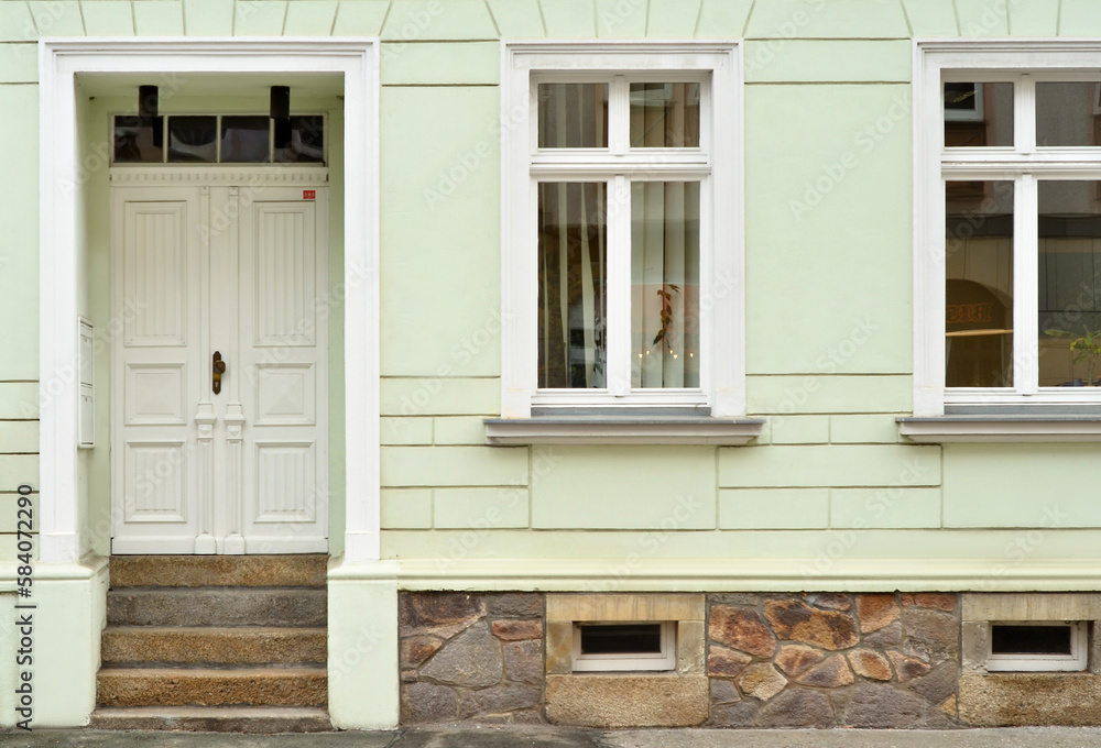 View of old building with wooden door and windows