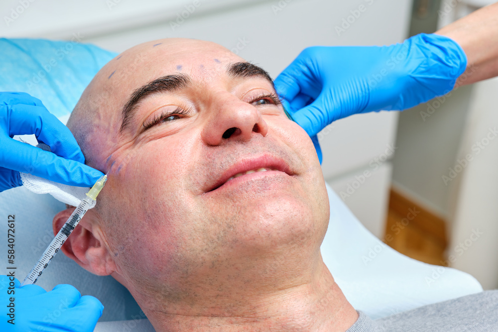 mature man over 40 years old getting anti wrinkle treatment on his face with botulinum toxin mature man over 40 years old getting anti wrinkle treatment on his face with botulinum toxin