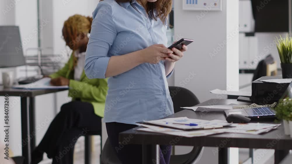 Female manager using mobile phone in executive office, scrolling on social media with smartphone. Young employee working on marketing vision with gadget, professional startup agency. Female manager using mobile phone in executive office, scrolling on social media with smartphone. Young employee working on marketing vision with gadget, professional startup agency.