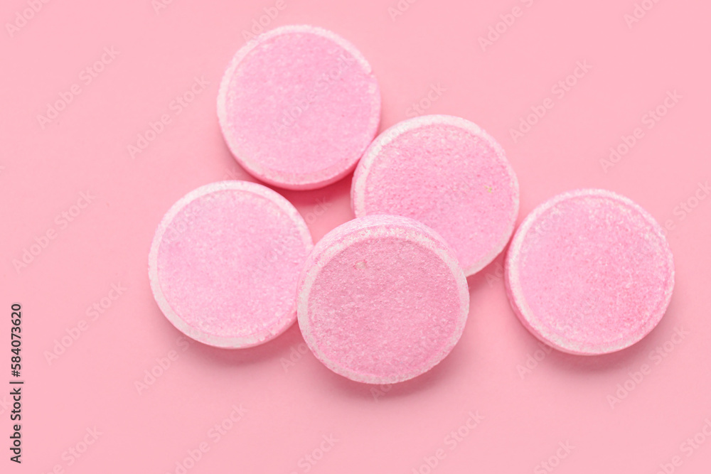 Soluble tablets on pink background Soluble tablets on pink background