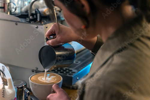 A latte artist pours a tulip  the first round challenge  during the Latte Throwdown held at on Mar 4. ..Photo By Stephen Day.