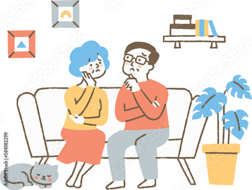 リビングで悩んでいる夫婦_色