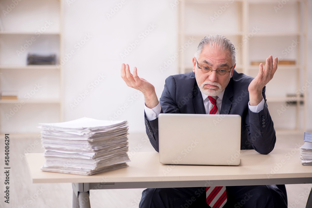 Old male employee and too much work at workplace Old male employee and too much work at workplace