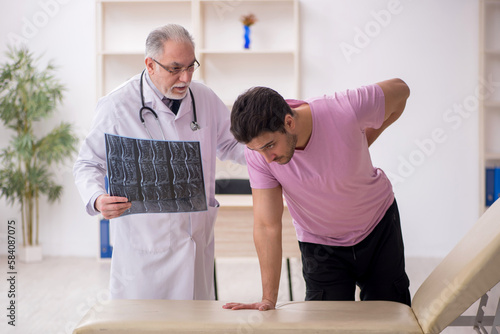 Young male patient visiting old male doctor radiologist