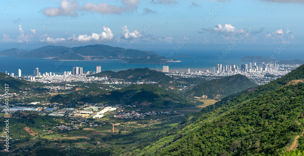 Panoramic photo of dawn viewed from the high mountains, in the distance is the famous coastal tourist city of Nha Trang, Vietnam