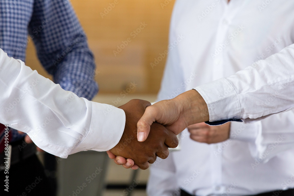 Close-up Business people shaking hands in modern conference room, business etiquette congratulation merger and acquisition digital banner concept. Close-up Business people shaking hands in modern conference room, business etiquette congratulation merger and acquisition digital banner concept.