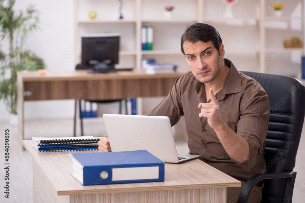 Young attractive employee sitting in the office Young attractive employee sitting in the office