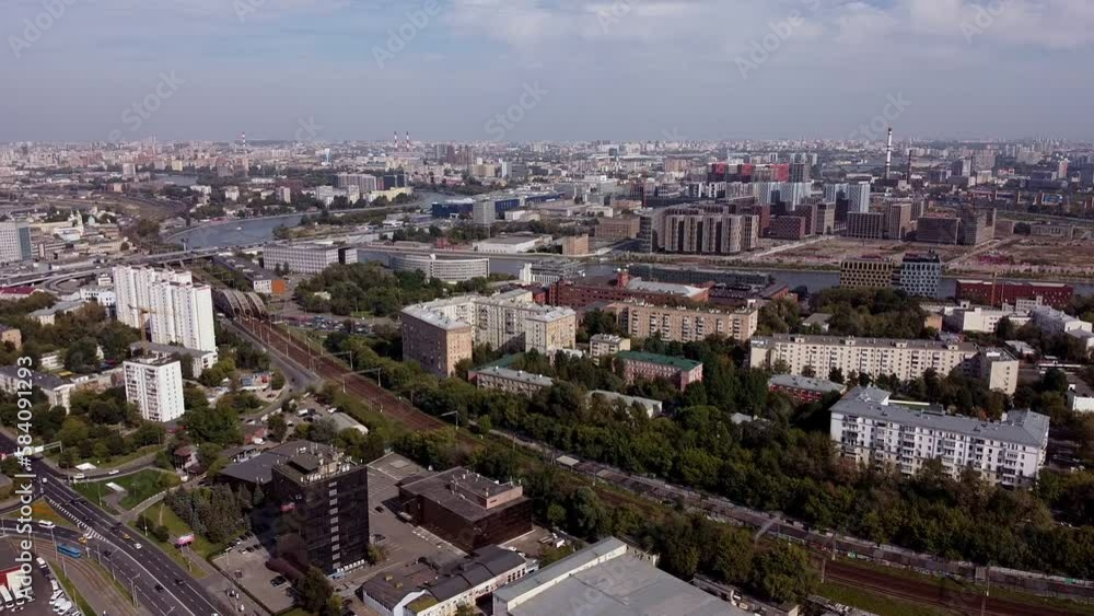 Aerial view of the summer cityscape. Railway in the city. Automobile bridge across the Moskva River. Developing urban infrastructure in the Moskovsky residential area Aerial view of the summer cityscape. Railway in the city. Automobile bridge across the Moskva River. Developing urban infrastructure in the Moskovsky residential area