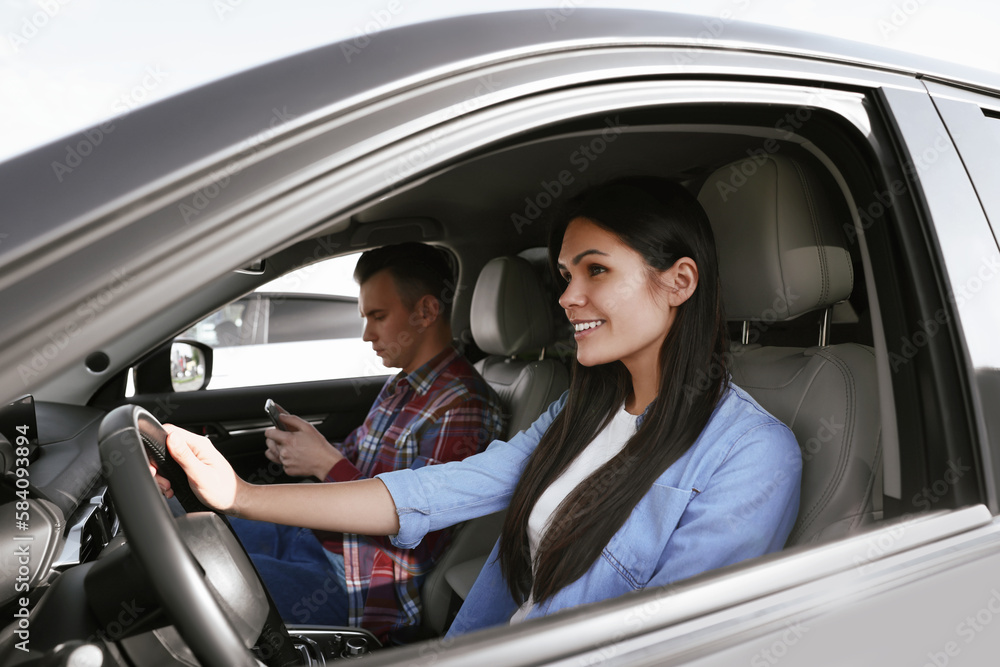 Happy young couple travelling together by car