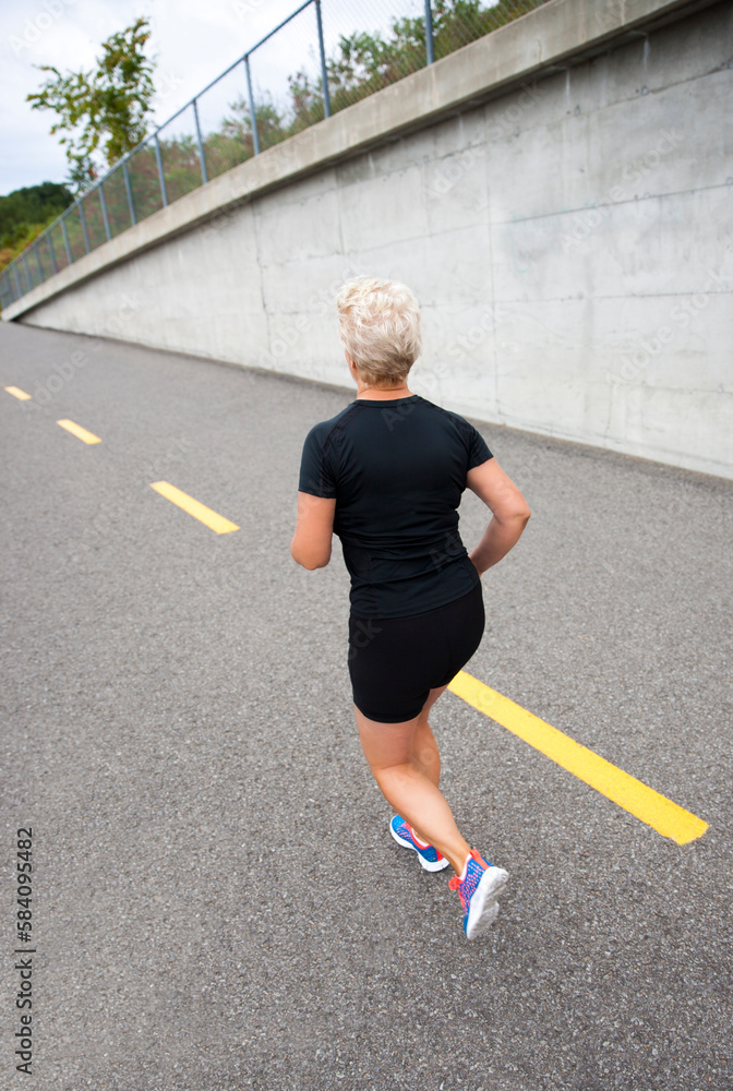 Attractive mature blond woman out for her morning run.