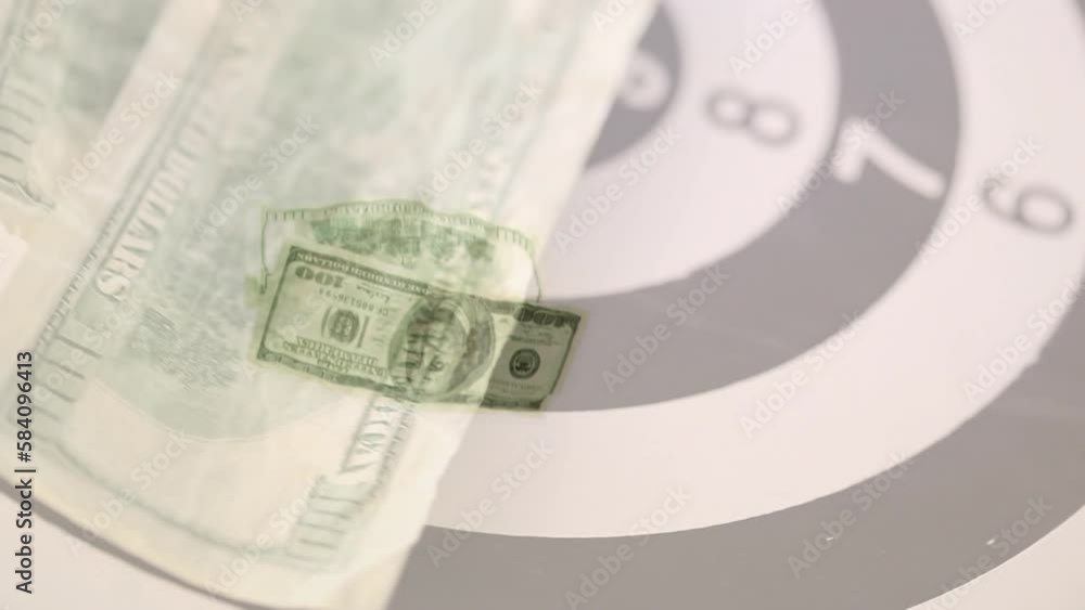 Animation of american dollar bills spinning over bull's eye Animation of american dollar bills spinning over bull's eye
