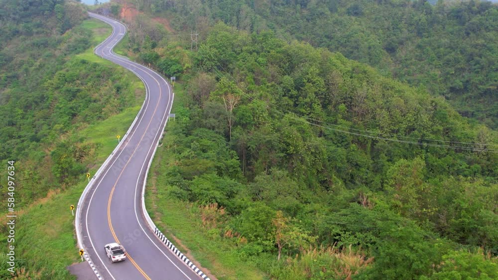 Aerial view of the road through the beautiful mountains with green jungle and important attractions of Nan Province, Road No.3 Aerial view of the road through the beautiful mountains with green jungle and important attractions of Nan Province, Road No.3