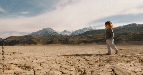 Fotografi Funny caucasian baby boy running on deserted ground